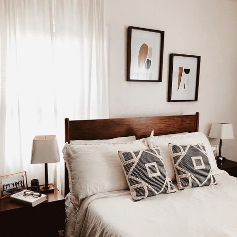 A Bed With White Sheets And Two Framed Pictures On The Wall pertaining to Alton Cherry Ii Queen Wood Platform Bed & Headboard 3 Piece Bedroom Set With 2 Nightstands