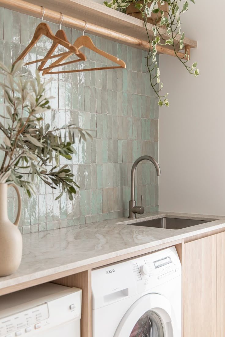 A Washer And Dryer In A Kitchen With Green Tiles On The Wall Behind It intended for