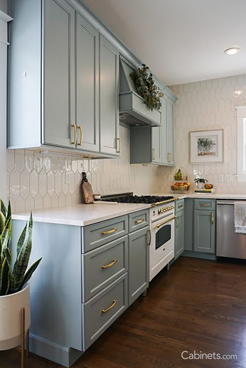 Charming Kitchen With Blue Green Cabinets And Brushed Gold Accents inside