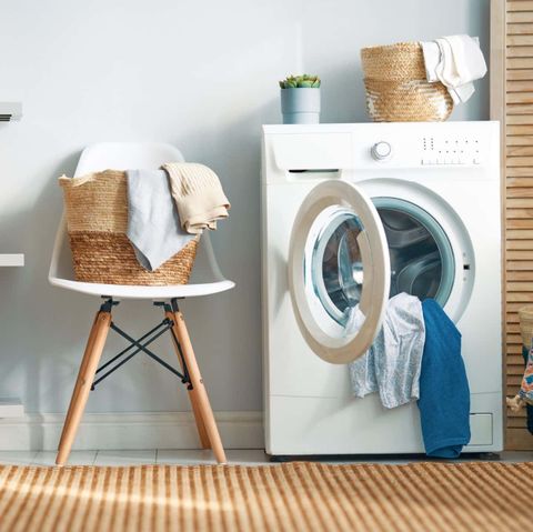 Download A White Washing Machine And Chair In A Room | Wallpapers.com pertaining to Laundry Room Makeover Ideas for a Happier Home