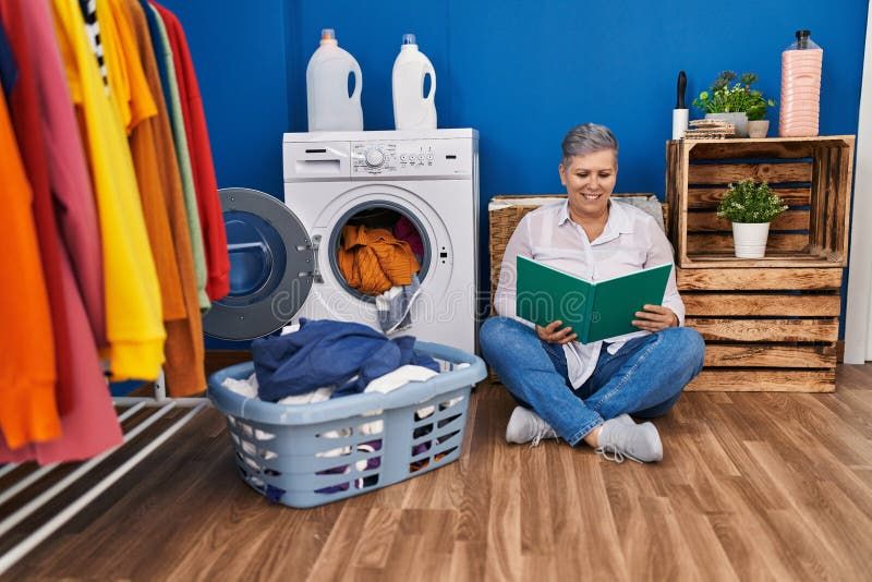 Middle Age Woman Reading Book Waiting For Washing Machine At Laundry ... with Beyond the Price Tag What the $4,100 Reader Laundry Room Offers Wisconsin