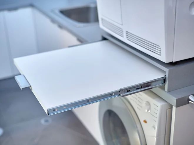 The Hardworking Laundry: Make Room For Folding | Custom Laundry Room, Stacked Laundry Unit ... with Clever Solutions for a Seamless Ironing Routine in a Compact Home