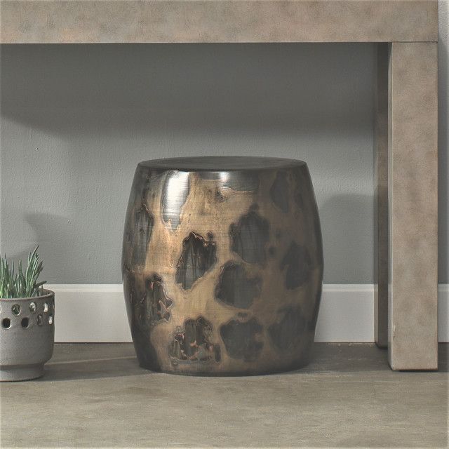 Creating visual depth with acid-washed round metal tables in interior spaces